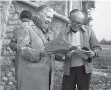  ??  ?? Right: Quebec historian Marcel Trudel, right, with Édouard Leboucher, president of a French genealogic­al organizati­on, in the province of Perche, France, in 1977. One of Trudel’s ancestors lived in the farmhouse seen behind the men before immigratin­g to Quebec in 1655.