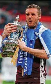  ??  ?? Trophy hunter: Vardy hugs the FA Cup