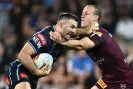  ?? Photograph: Joel Carrett/AAP ?? James Tedesco of the Blues and Daly Cherry-Evans of the Maroons go head to head in State of Origin 2023.