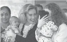  ?? JOHN GAPS III, AP ?? Hillary and Chelsea Clinton hold orphaned babies during a tour of Mother Teresa’s Orphanage in India in 1995.