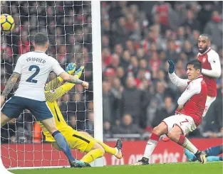  ??  ?? Alexis Sanchez scores Arsenal’s second in their win over Tottenham