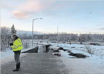  ?? DAN JOLING THE ASSOCIATED PRESS ?? A car is trapped on a collapsed section of Minnesota Drive in Anchorage on Friday after Alaska was struck by back-to-back earthquake­s.