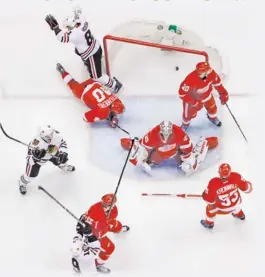  ??  ?? Chicago Blackhawks right wing Marian Hossa (81), of the Czech Republic, top left, celebrates his goal against the Detroit Red Wings during the first period in Game 6 of the Western Conference semifinals in the NHL hockey Stanley Cup playoffs in...