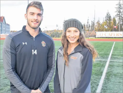  ?? JEREMY FRASER/CAPE BRETON POST ?? Jesse MacIntyre, left, and Becky Hanna of the Cape Breton Capers men’s and women’s soccer teams stand on the field at the Cape Breton Health Recreation Complex on Wednesday. The local soccer players will play in front of family and friends this weekend when the Capers host the Atlantic University Sport Championsh­ips, beginning today, in Sydney.