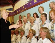  ??  ?? On song Margaret Pringle leads the Cambus Singers in 2009