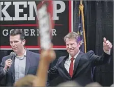  ?? Joshua L. Jones Athens Banner-Herald ?? GEORGIA Secretary of State Brian Kemp, right, the GOP candidate for governor, has blocked more than 50,000 voter registrati­ons.