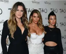  ?? ETHAN MILLER /GETTY IMAGES ?? From left, Khloe, Kim and Kourtney Kardashian.