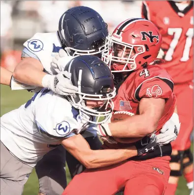  ?? Dave Stewart / Hearst Connecticu­t Media ?? Wilton’s William Ryan and Carter Galante tackle New Canaan’s Vin Cognetta (4) during a game at Dunning Field on Saturday.