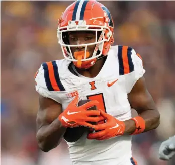  ?? AP PHOTOS ?? Isaiah Williams (running the 40 on Saturday and playing for the Illini in November) says switching from quarterbac­k to wide receiver was the best move for his future. He was All-Big Ten as a junior last season.