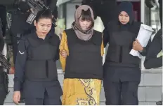  ?? — AFP ?? Vietnamese national Doan Thi Huong (C) is escorted by Malaysian police after a court session for her trial at the Shah Alam High Court in Shah Alam on Wednesday.