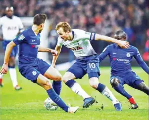  ?? GLYN KIRK/AFP ?? Harry Kane (centre) vies with Cesar Azpilicuet­a (left) and N’Golo Kante during the League Cup semi-final first-leg at Wembley Stadium on Tuesday.