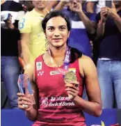  ?? PHOTO: PTI ?? P V Sindhu poses with the gold medal and trophy after winning against Japan’s Nozomi Okuhara during the women’s singles final match at the Korea Open Super Series in Seoul, South Korea, on Sunday