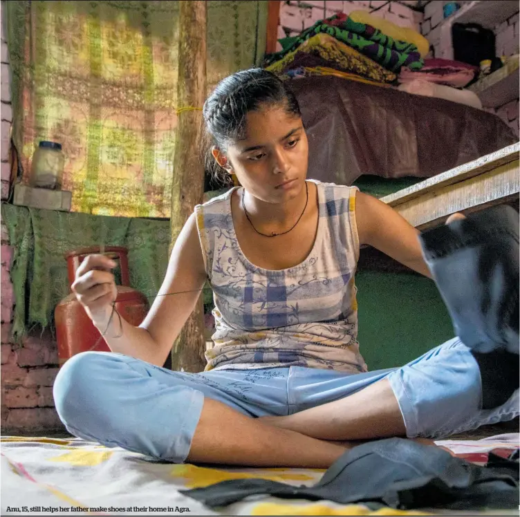  ??  ?? Anu, 15, still helps her father make shoes at their home in Agra.