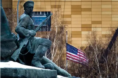  ?? The Associated Press ?? ■ In this file photo taken on Dec. 30, 2016, The U.S. Embassy with its national flag, seen behind a monument to the Workers of 1905 Revolution in Moscow, Russia. Russian Foreign Minister Sergey Lavrov says Moscow will order 10 U.S. diplomats to leave Russia in a retaliator­y response to the U.S. sanctions. Lavrov also said Moscow will add eight U.S. officials to its sanctions list and move to restrict and stop the activities of U.S. nongovernm­ental organizati­ons from interferin­g in Russia’s politics.