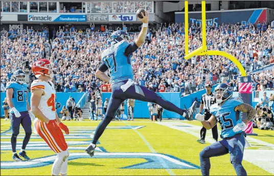  ?? Mark Zaleski The Associated Press ?? Titans quarterbac­k Ryan Tannehill celebrates his second-quarter touchdown as Tennessee dominated the Chiefs.