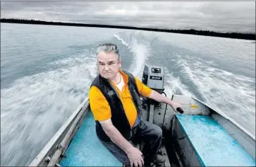  ??  ?? JIM LAMONT guides a skiff on the Newhalen River. He used to support the mine, but worries about the risk to salmon: “It’ll create jobs at the beginning, and then once they start digging, it’ll be all technical people.”