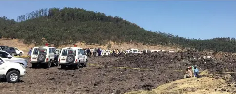  ??  ?? A general view shows the scene of the Ethiopian Airlines Flight ET 302 plane crash, near the town of Bishoftu, southeast of Addis Ababa, Ethiopia.