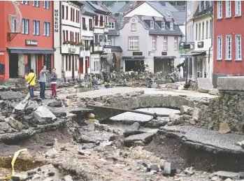  ?? INA FASSBENDER / AFP VIA GETTY IMAGES ?? The pedestrian area of Bad Muensterei­fel, western Germany, is pictured after floodwater­s tore through the area amid heavy rain. More than 120 people have died in Europe due to the flooding, most of them in western Germany.