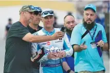  ?? AP PHOTO/JOHN RAOUX ?? Fans takes photos with NASCAR driver Kevin Harvick, center, in the garage area during a Feb. 17 practice session at Daytona Internatio­nal Speedway. Harvick plans to retire after this Cup Series season.