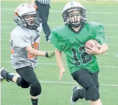  ?? ED TELENKO/SPECIAL TO POSTMEDIA NEWS ?? St. Catharines Seahawks back Braiden Genest, No. 12, scored two touchdowns in atom football action against the Niagara Falls Lions Sunday at Kiwanis Field in St. Catharines.