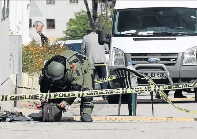  ?? PHOTO: EPA ?? A Turkish bomb expert examines the area after an attacker armed with a knife tried to stab a security guard, who fired a warning shot before shooting the man in the leg, local media reported.