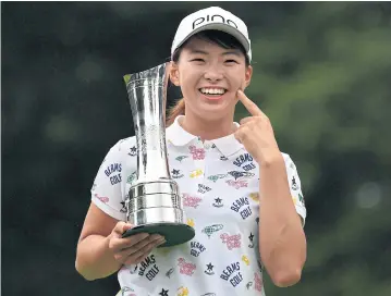  ?? AFP ?? Japan’s Hinako Shibuno celebrates with the trophy after her win at the Women’s British Open at Woburn.