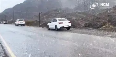  ?? ?? Motorists pass by a road during heavy rain.