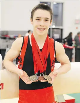  ??  ?? Samuel Zakutney shows off his medals from the 2013 national gymnastics championsh­ips held at Carleton University.