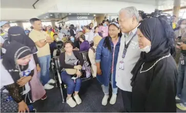  ?? ?? Transporta­tion Secretary Jaime Bautista inspects the situation at NAIA Terminal 1 on Friday, Oct. 27, as the annual Undas exodus out of Metro Manila begins.