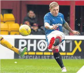  ??  ?? Rangers’ Martyn Waghorn slots away his goal in style.