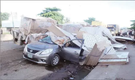  ??  ?? An untied heavy load at the back of a truck fell off due to bad road and crashed on two motor cycles and a Nissan car with Registrati­on No. LAGOS KRD 572CY, injuring an Indian occupant, along Creek Road, Apapa, Lagos… yesterday