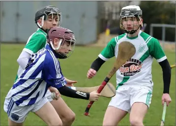  ??  ?? Seán Nunan (Good Counsel College) bursting past St. Peter’s pair Seán Cooney and Fionn Ryan.