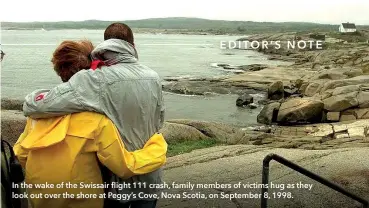 ?? ?? In the wake of the Swissair flight 111 crash, family members of victims hug as they look out over the shore at Peggy’s Cove, Nova Scotia, on September 8, 1998.