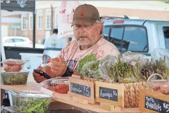  ?? Jeremy stewart ?? Kip Bishop with Edengate Farm in Kingston talks while at his booth at the Rockmart Farmers Market on Thursday, June 23, 2022. Bishop said there is no food supply shortage when it comes to farmers markets.