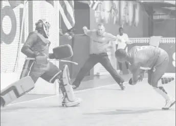  ??  ?? Just wide-Guyana’s Marvin Dannett (center) firing a glorious opportunit­y wide of the right corner, during his team’s clash with Trinidad and Tobago in the Pan American Indoor Hockey Championsh­ip at the Cliff Anderson Sports Hall.