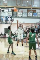  ?? Tim Godbee ?? Calhoun freshman forward Emaree Winston lets a three-point shot rip against Adairsvill­e.