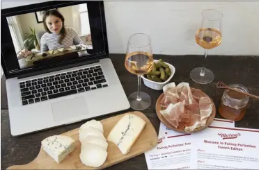  ?? HONS—ASSOCIATED PRESS ?? This image released by Murray’s Cheese shows a display of cheeses in front of a laptop showing a virtual class about cheese. In this pandemic climate, there are lots of ways to make this Valentine’s Day feel special without putting your health at risk or spending a lot of cash. Murray’s Cheese has expanded their selection of virtual classes, which include one on making cheese boards, and one on creating a “Most Decadent Valentine’s Day.” All the classes can be taken live or bought to view later.
