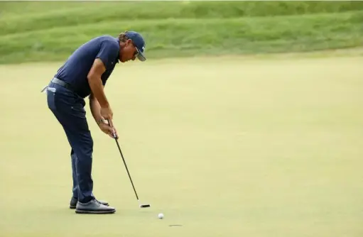  ??  ?? Maddie Meyer/Getty Images
Phil Mickelson putts on the seventh green during the second round of the Travelers Championsh­ip Friday at TPC River Highlands in Cromwell, Conn.