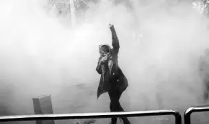  ??  ?? A protester in the University of Tehran’s demonstrat­ions in 2018