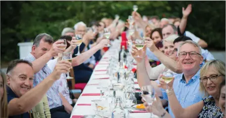  ??  ?? Visitors enjoying a long table feast al fresco at Ballinvill­in House, Mitchelsto­wn last weekend