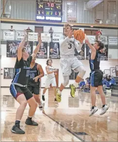  ?? Tim Godbee ?? Calhoun sophomore Peyton Law battles for a basket during the Yellow Jackets’ game against the Ringgold Tigers at Calhoun High School on Tuesday.