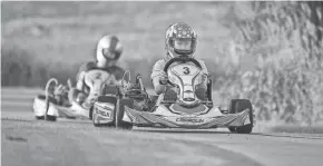  ?? DAVE KALLMANN / MILWAUKEE JOURNAL SENTINEL ?? Sam Mayer races karts with family friends on the track at the Mayers' home in Franklin.