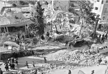  ??  ?? Syrian men and civil defence volunteers search for survivors amid the rubble of a building following a reported air strike the previous night on the northweste­rn city of Idlib. — AFP photo