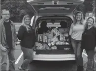  ?? SUBMITTED PHOTOS ?? Above, staff members from Chesapeake-Potomac Home Health Agency pose for a photo after loading their donations into the Miles’ family van. Other businesses and organizati­ons donating supplies were the Lunchbox Cafe, Dave Elder-Environmen­tal Associates, the Outback Steakhouse in St. Mary’s County, Shiloh United Methodist Church and Indian Head United Methodist Church. Below, six-year-old twins Bailey and Aaryn Miles make sure the boxes of supplies, hope and love get to those who need it.