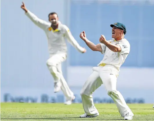  ?? Picture: REUTERS ?? GOTCHA!: Australia’s David Warner, right, and teammate Nathan Lyon celebrate after Warner took the catch to dismiss England’s Matt Prior during the first Ashes test