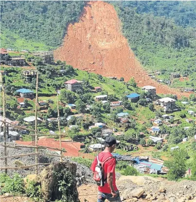  ?? Picture: Getty. ?? A boy walks in a part of the Sierra Leone capital, Freetown, after the mudslide struck.