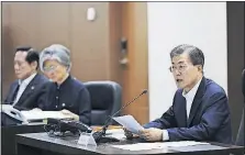  ?? [YONHAP] ?? In response to North Korea’s latest missile launch, South Korean President Moon Jae-in, right, presides over a meeting of his country’s National Security Council in Seoul early Saturday. North Korea launches missile Friday morning