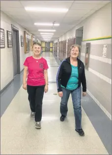  ?? CONTRIBUTE­D ?? Sandra Turnbull, a walker and volunteer for the Digby Area Recreation Commission’s indoor walking program at Digby Regional High School, and Holly Thomas, one of the program’s participan­ts, make their way through one of the hallways during a program session at the Digby school.