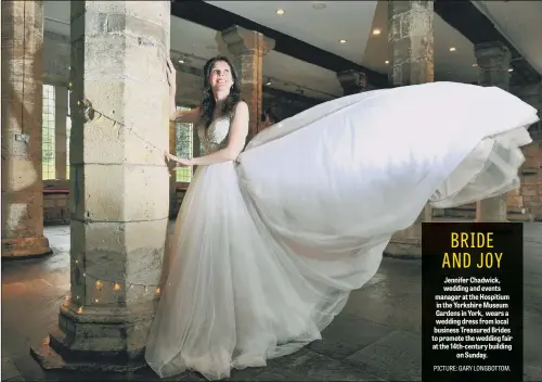  ??  ?? Jennifer Chadwick, wedding and events manager at the Hospitium in the Yorkshire Museum Gardens in York, wears a wedding dress from local business Treasured Brides to promote the wedding fair at the 14th-century building on Sunday.