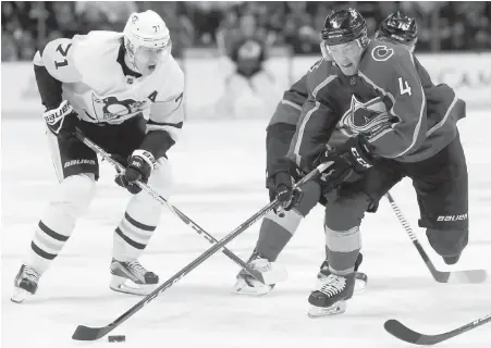  ??  ?? Avalanche defenceman and Langford product Tyson Barrie drives to the net in front of Penguins centre Evgeni Malkin during the first period in Denver on Monday.